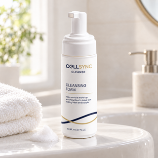 CellSync Cleansing Foam with CLEANSE protocol label and navy and gold interlock beside a bathroom basin.